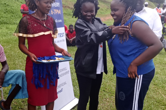 The Gender Minister awarding the Chief mobilizer during the games